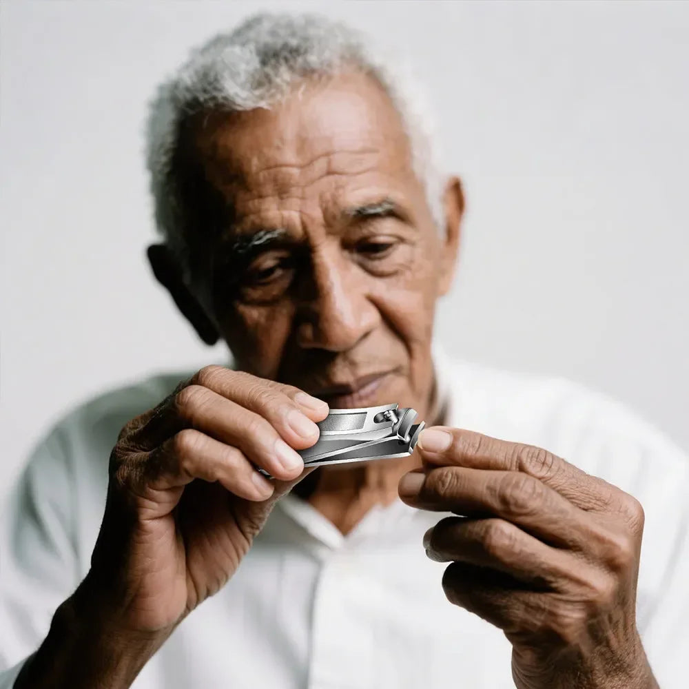 Elderly man using precision nail clippers for easy at-home grooming
